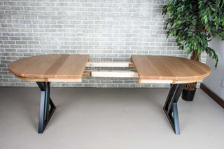 extendable oval dining table in rock maple on black steel legs