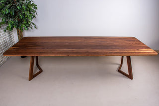 Walnut dining table on walnut chevron legs.
