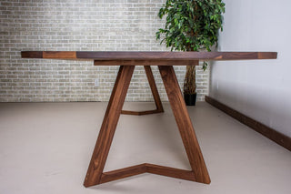 Walnut dining table on walnut chevron legs.