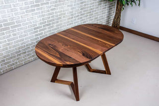 extendable oval table in walnut on walnut chevron legs