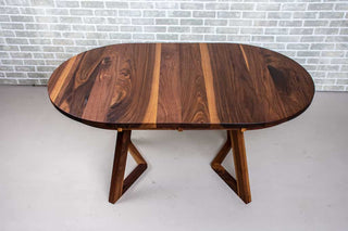 extendable oval table in walnut on walnut chevron legs