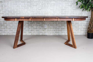 extendable oval table in walnut on walnut chevron legs