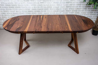 extendable oval table in walnut on walnut chevron legs