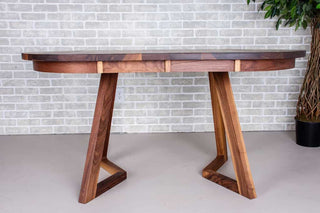 extendable oval table in walnut on walnut chevron legs