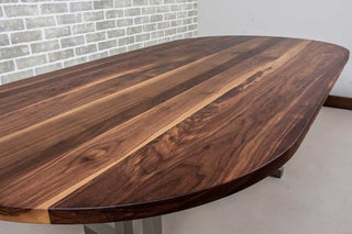 oval walnut table on nickel colored steel legs