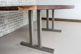 oval walnut table on nickel colored steel legs