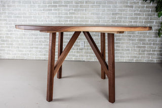 Round walnut table on wood base