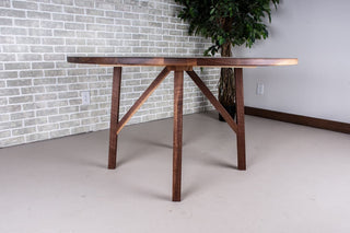 Round walnut table on wood base