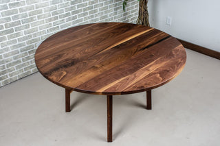 Round walnut table on wood base