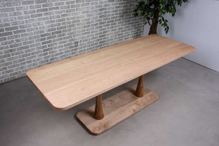 long wood dining table in maple on double pedestal base