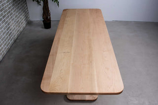 long wood dining table in maple on double pedestal base