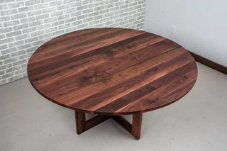 round walnut table in spiced finish on pedestal base