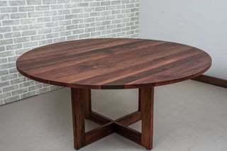 round walnut table in spiced finish on pedestal base