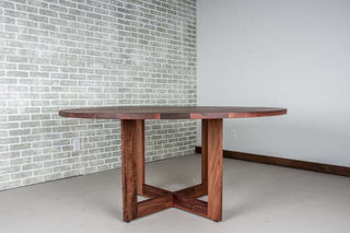 round walnut table in spiced finish on pedestal base