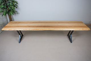 Live edge ash dining table on steel legs.