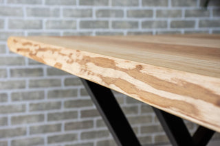 Live edge ash dining table on steel legs.