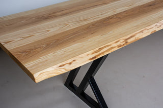 Live edge ash dining table on steel legs.