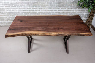 Live edge walnut table on burnt penny steel legs.