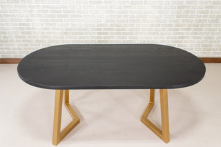 black oval table on gold steel legs