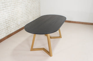 black oval table on gold steel legs