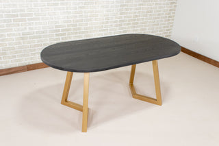 black oval table on gold steel legs
