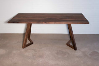 walnut dining room table on chevron legs
