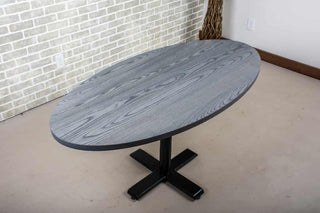 modern dining table finished in iron on pedestal base