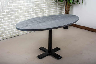 modern dining table finished in iron on pedestal base
