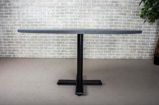 modern dining table finished in iron on pedestal base