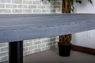 modern dining table finished in iron on pedestal base