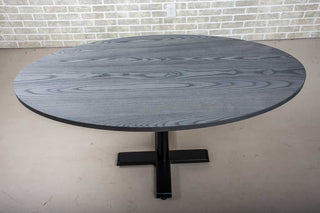 modern dining table finished in iron on pedestal base