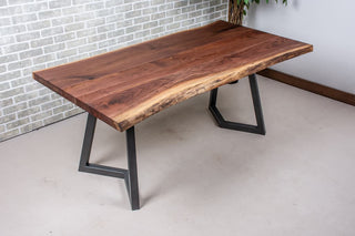 Live edge walnut table on gunmetal grey steel legs.