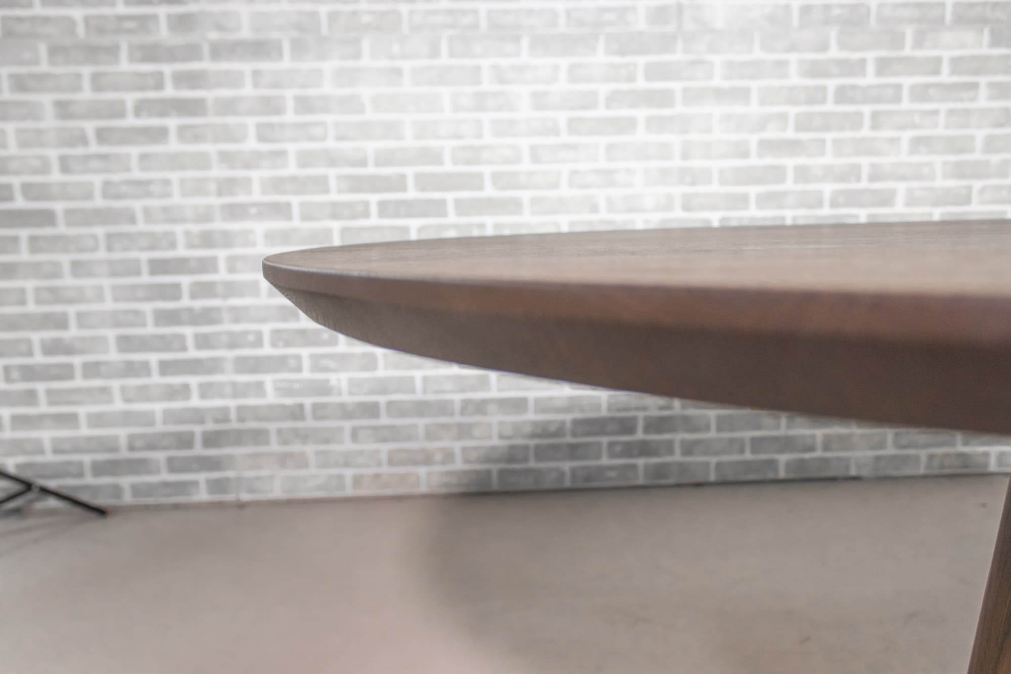 Nautley edge of elliptical oval oak table on a cone base in espresso