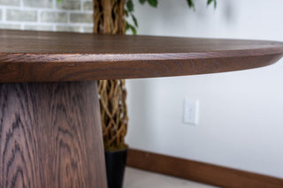 round oak table in espresso on cone pedestal base