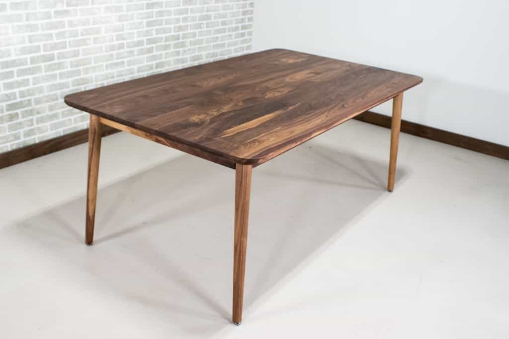 midcentury parsons table in walnut on skinny legs