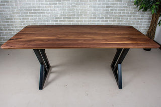 Walnut dining table on steel legs.