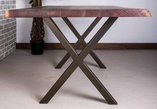 Live edge walnut table on bronze X-shaped steel legs.