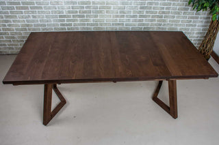 Dark wood extendable dinner table.