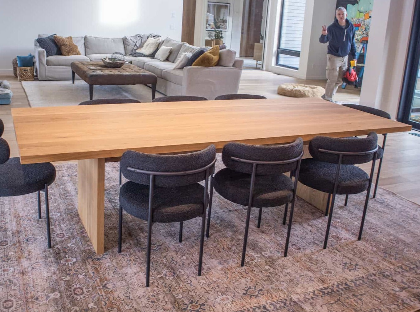 large oak dining table on wood panel legs