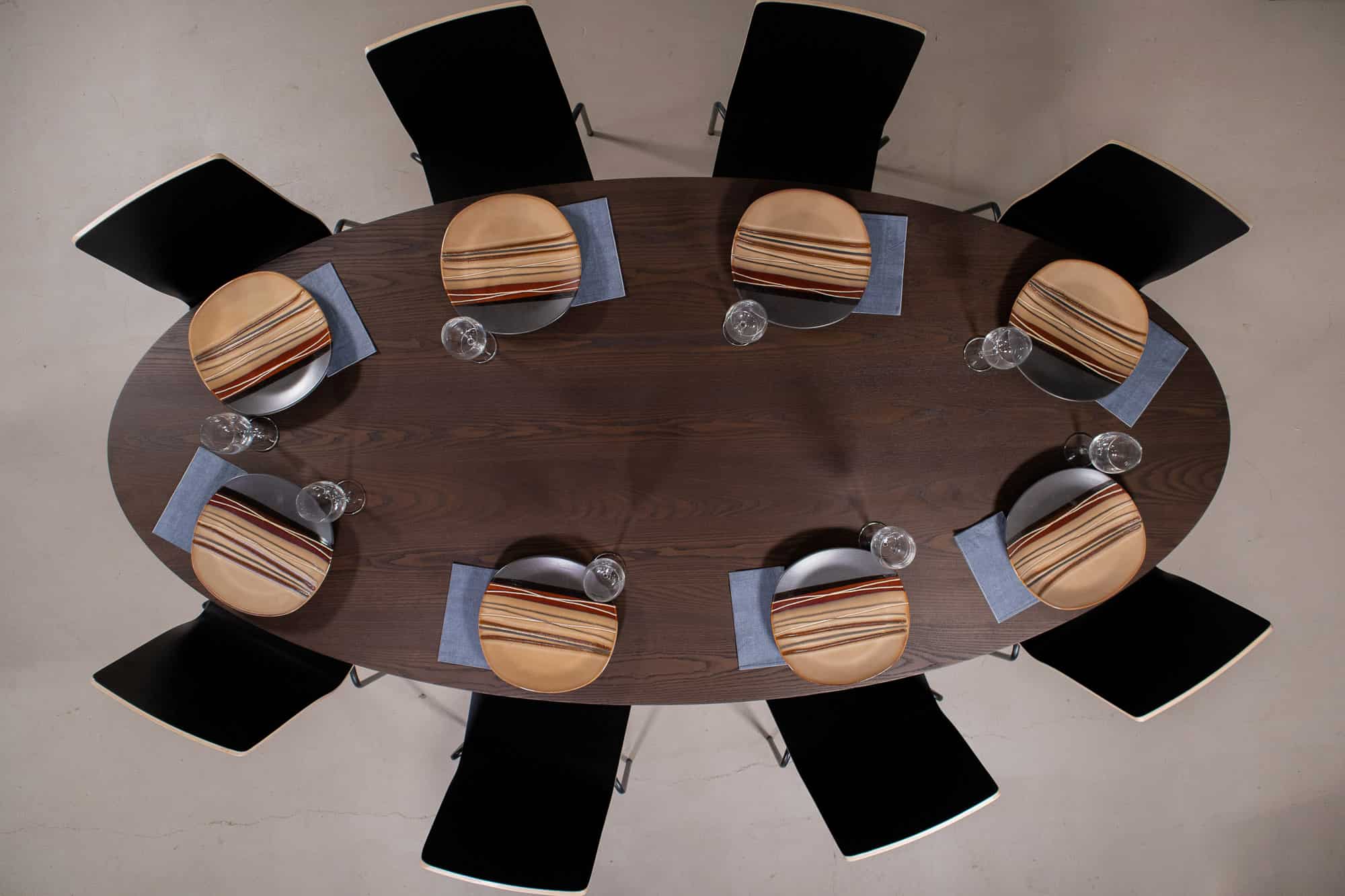 Elliptical oval oak table on a cone base in espresso