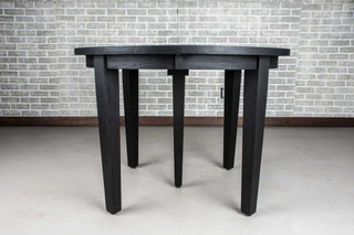 round oak extendable table in black on wood base