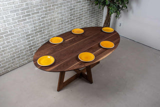 walnut ellipse table with thin edge on cross base