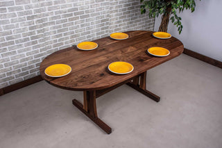 walnut oval table on custom trestle pedestal