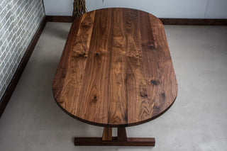 walnut oval table on custom trestle pedestal