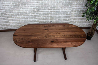 walnut oval table on custom trestle pedestal