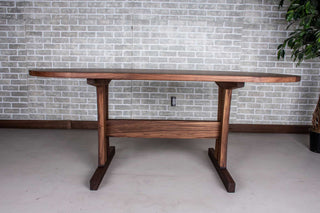 walnut oval table on custom trestle pedestal