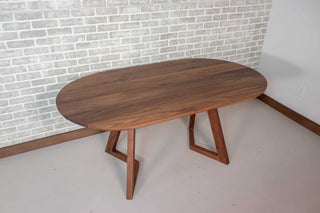 oval walnut table on wood legs