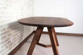 oval walnut table on wood legs