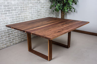 Walnut square table on square U legs.
