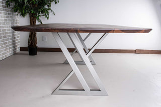 minimalist walnut table on nickel colored steel legs